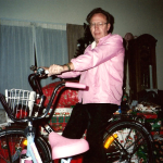 a pastor on pink bike